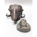 A bronze ram's head and a bronze relief