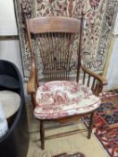 An early 20th century oak and beech American spindle-back elbow chair, width 60cm, depth 45cm,