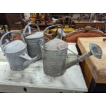 Three vintage galvanized watering cans