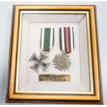 A German WWII Mother's Cross, rare unfinished, framed WWI Iron Cross and Cross of Honour and two