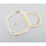 A single strand graduated cultured pearl necklace, with diamond set 9ct clasp, 43cm, a double strand