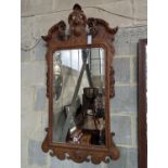 An 18th century style carved wood wall mirror, width 64cm, height 124cm