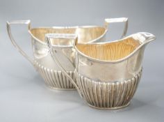 A late Victorian fluted silver cream jug and matching sugar bowl, by Walker & Hall, Sheffield,