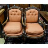 A set of four 19th century French carved walnut elbow chairs with buttoned fabric upholstery,