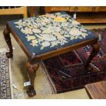 A George III style mahogany stool with drop in tapestry seat on ball and claw feet, signed JS