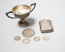 A silver vesta case, a small silver trophy cup and five assorted coins including a Charles II half