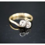 An 18ct & plat, two stone diamond crossover ring, size J, gross weight 1.8 grams.