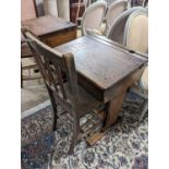 A vintage oak student's desk, width 57cm, depth 46cm, height 71cm with a beech and elm chair