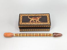 A Victorian Tunbridge ware ebony ground 'dog' ring box, width 9cm, and a stickware glove stretcher