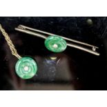 A yellow metal mounted jade and diamond set circular pendant, 14mm, on a 585 rope twist chain and