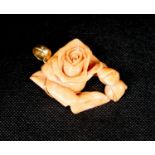 A yellow metal mounted carved coral 'rose' pendant, 49mm, gross weight 40 grams.