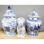 2 modern Chinese blue and white vases and covers and a similar model of a dog.