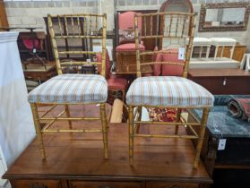 A pair of Regency simulated bamboo gilt wood side chairs with striped seats