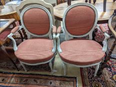 A pair of early 20th century French painted upholstered armchairs, width 59cm, depth 48cm, height