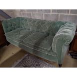A late Victorian Chesterfield settee upholstered in buttoned green fabric, length 194cm, depth 80cm,
