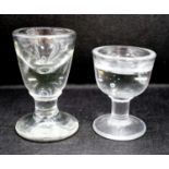 A Georgian deceptive Toastmasters glass and a later penny lick type glass, tallest 10 cm