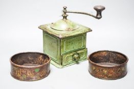 A pair of 19th century toleware coasters and a painted coffee grinder