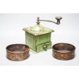 A pair of 19th century toleware coasters and a painted coffee grinder