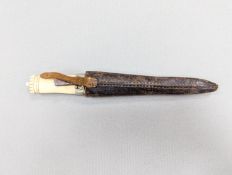 An antique Norwegian marine ivory hunting knife, with carved and pierced scabbard and leather