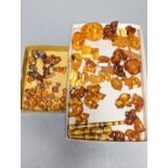 A mixed collection small carved amber wares including dice, eggs and cigarette holders, etc.