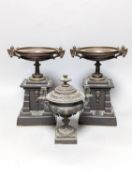 A pair of bronze tazzas on architectural slate bases, c.1900, together with a third, associated