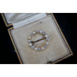 An Edwardian yellow metal, diamond and seed pearl set open work circular brooch, 20mm, gross 2.9