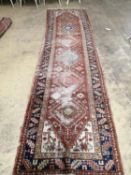 † An antique Heriz runner, 362 x 95cmThe property of Bath and Racquets Club