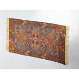 A Caucasian style petit point miniature rug 33x20cm