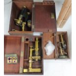 Three mahogany cased travelling microscopes and cased lenses