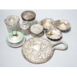A silver and enamel mounted glass toilet jar, four other toilet jars, a hand mirror and three