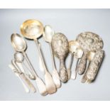 A group of silver flatware including a Victorian soup ladle and two basting spoons and three