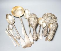 A group of silver flatware including a Victorian soup ladle and two basting spoons and three