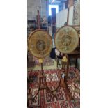 A pair of 19th century mahogany pole screens, with oval silkwork banners, height 148cm