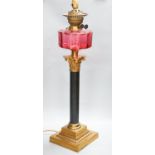 And early 20th century Corinthian column brass and cranberry glass oil lamp, converted for