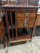 An Edwardian inlaid rosewood revolving bookcase fitted three drawers, width 52cm, depth 51cm, height