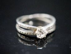 A yellow metal and single stone diamond ring, with diamond chip set split shoulders, size K, gross