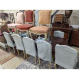 A set of fourteen French Louis XV style painted upholstered dining chairs with loose covers