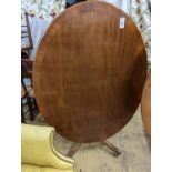 Attributed to William Tillman. A reproduction George III style oval mahogany pedestal tilt top