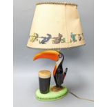 A Guinness toucan lamp, with original shade, tail repairedTotal height including shade 43.5 cm
