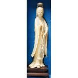 An early 20th century Chinese ivory figure of Guanyin holding a Buddhist rosary 25cm, wood stand and