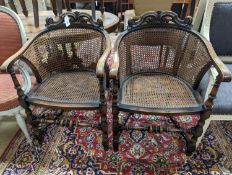 A pair of early 20th century Carolean style caned beech tub framed chairs, width 56cm, depth 48cm,