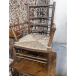 A late 19th century beech rush seated Sussex elbow chair, (cut down) width 55cm, depth 44cm,
