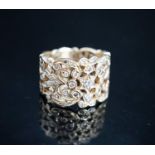 A continental pierced 14k and diamond chip set band, size L/M, gross weight 8.2 grams.
