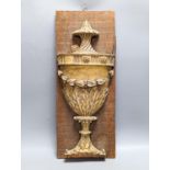 An 18th/19th century carved wood and gilt gesso urn relief, later mounted, 57x23cm