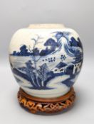 An 18th century Chinese provincial blue and white jar on a wooden stand. 25cm including stand