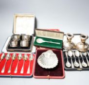 A cased pair of four 1920's silver napkin rings, four other cased items including butter shell and a