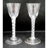 Two George III double series opaque twist stem cordial glasses, c.1765, each with a funnel shaped