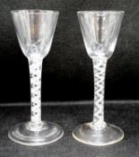 Two George III double series opaque twist stem cordial glasses, c.1765, each with a funnel shaped
