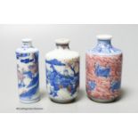 Three Chinese underglaze blue and copper red snuff bottles, 9cm