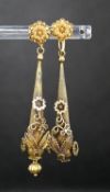 A pair of Victorian texture yellow metal pear shaped drop earrings, with star and foliate motifs(a.